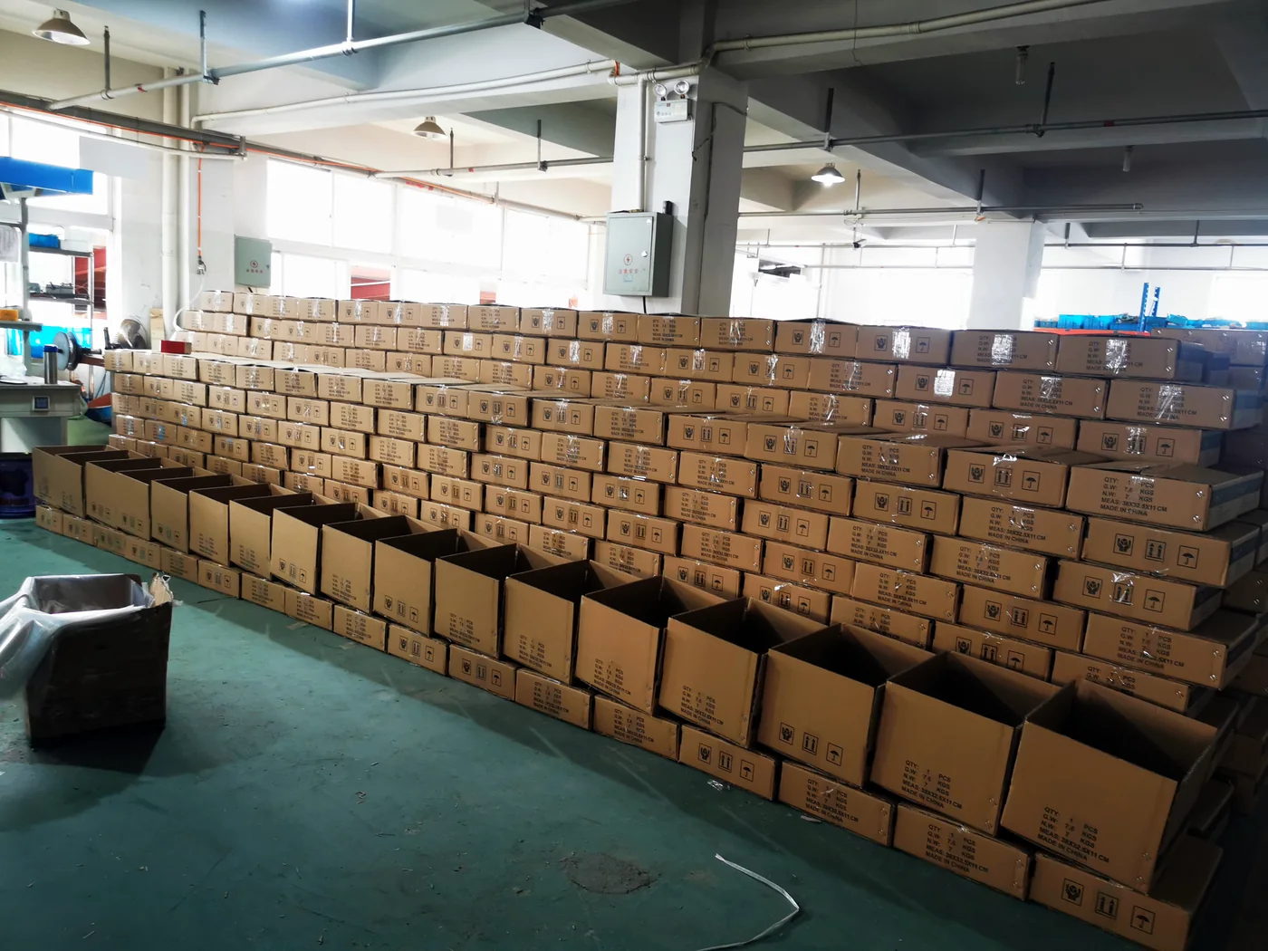 Rows of export cartons staged in the workshop for shipment