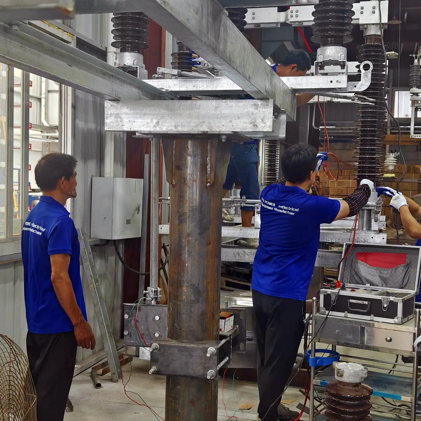 Workshop operator assembling a metal frame for electrical equipment production